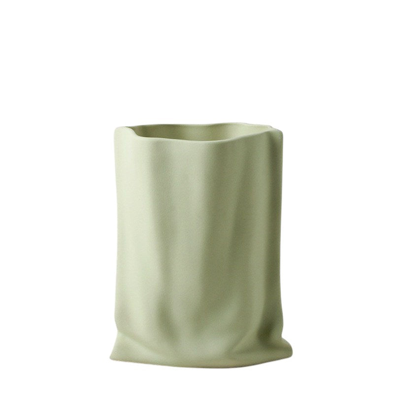 HOMELIVY matcha green ceramic vase with a unique crinkled paper bag design and matte texture.