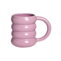 HOMELIVY pastel purple doughnut-shaped ceramic mug with a ribbed design held by a hand