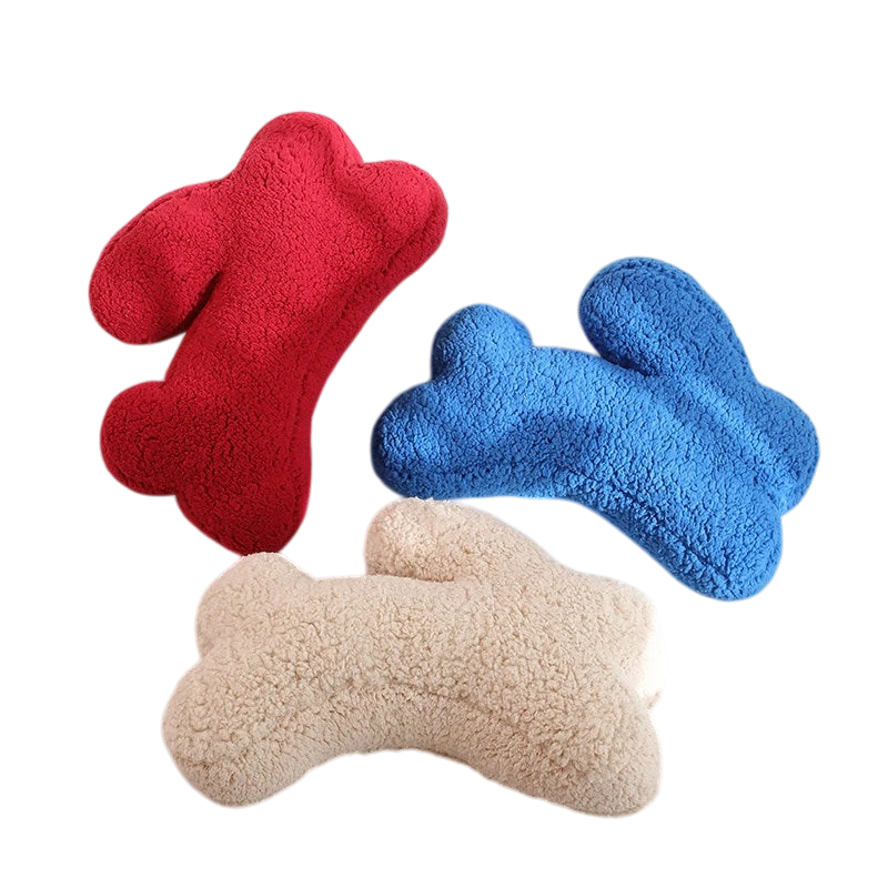 HOMELIVY plush bone-shaped pillows in red, blue, and beige, perfect for pets or decor.