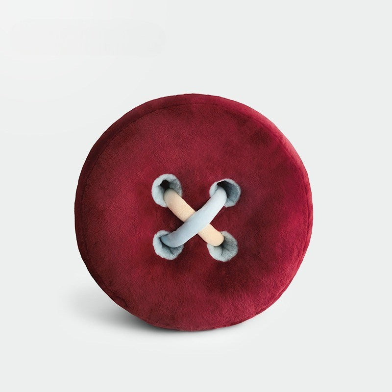 HOMELIVY plush button cushion in deep red with light blue and beige stitching detail.