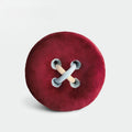 HOMELIVY plush button cushion in deep red with light blue and beige stitching detail.