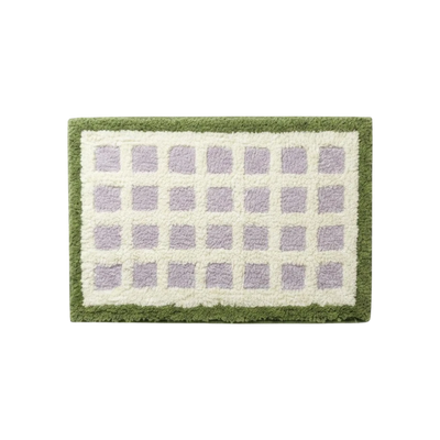 HOMELIVY rectangular bath mat featuring a purple and cream checkered pattern with a textured olive green border.