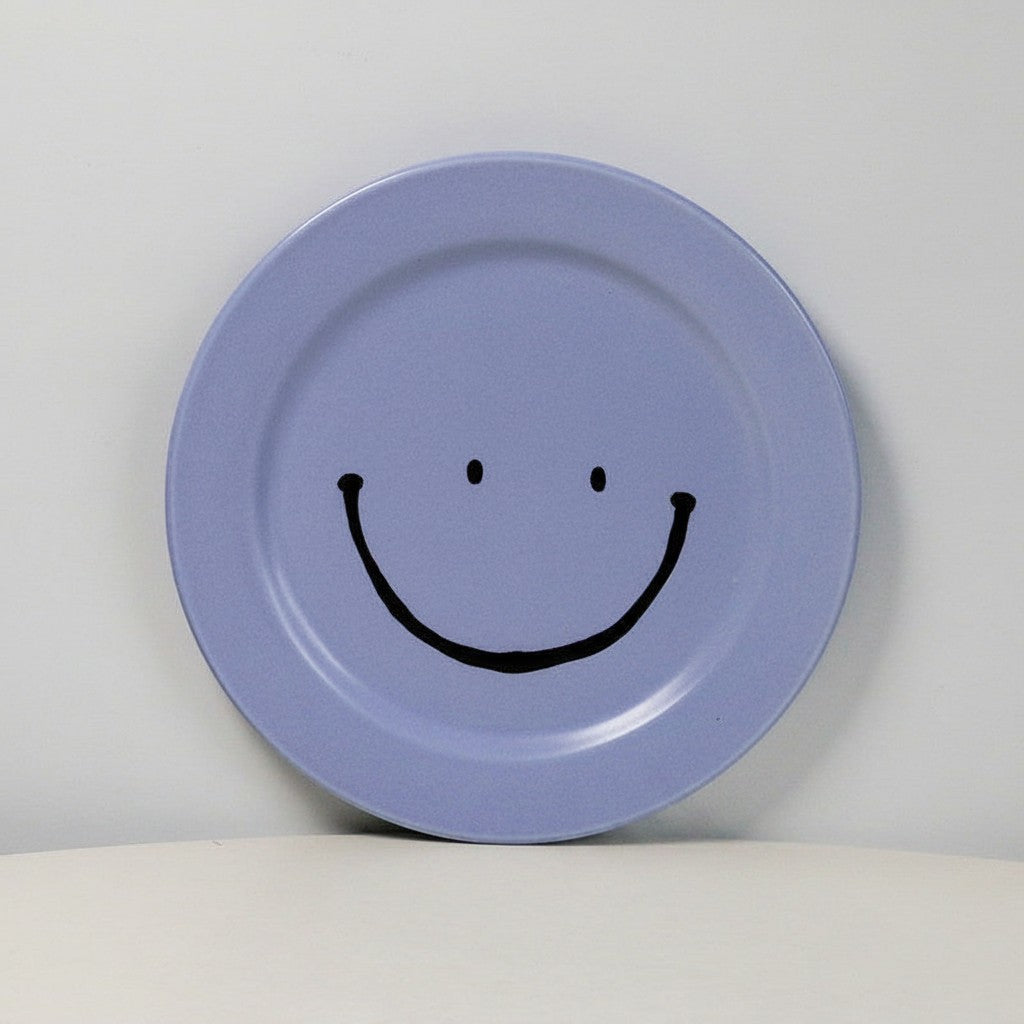 HOMELIVY light purple ceramic plate featuring a hand-drawn black smiley face design on a minimalist background