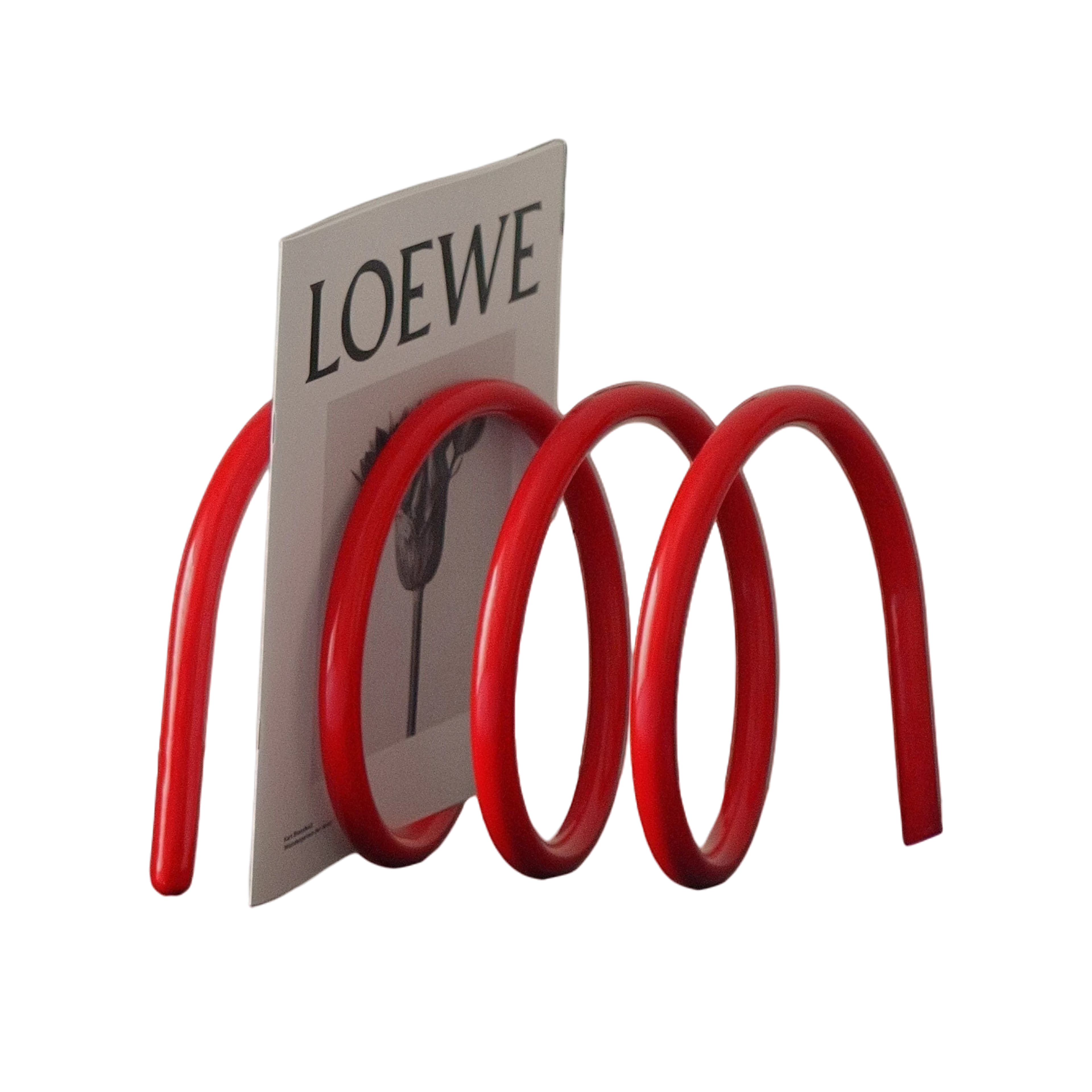 HOMELIVY red spiral book holder with a sculptural wave design, displayed on a modern cabinet with a magazine.