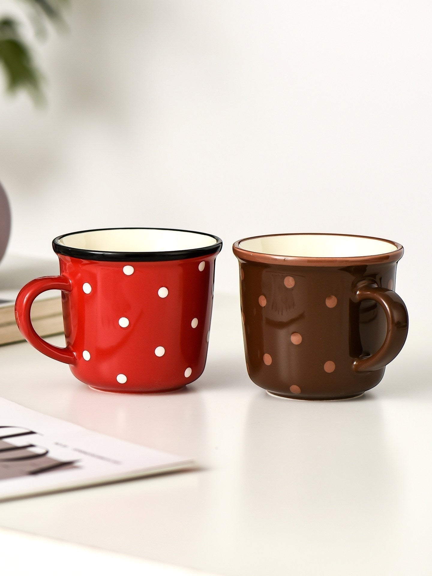 HOMELIVY retro ceramic mugs in red and brown with white polka dots and glossy contrast rims on a white table.