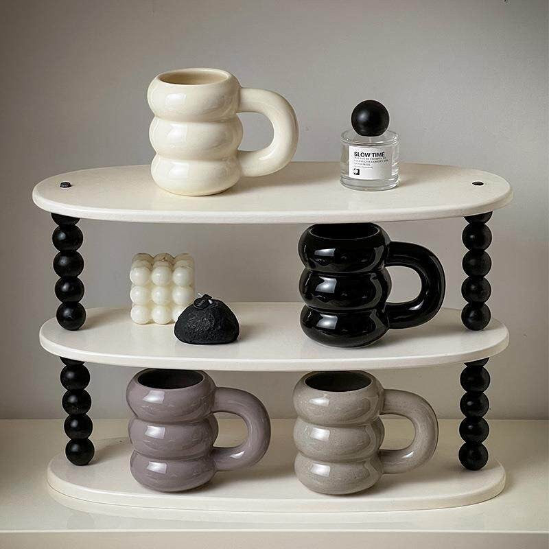HOMELIVY Nordic Sculptural Bubble Coffee Mug in cream, black, and grey ceramic with a unique stacked-ring silhouette and oversized handle.