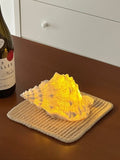 HOMELIVY decorative seashell LED light with warm yellow glow, battery powered for portable use.