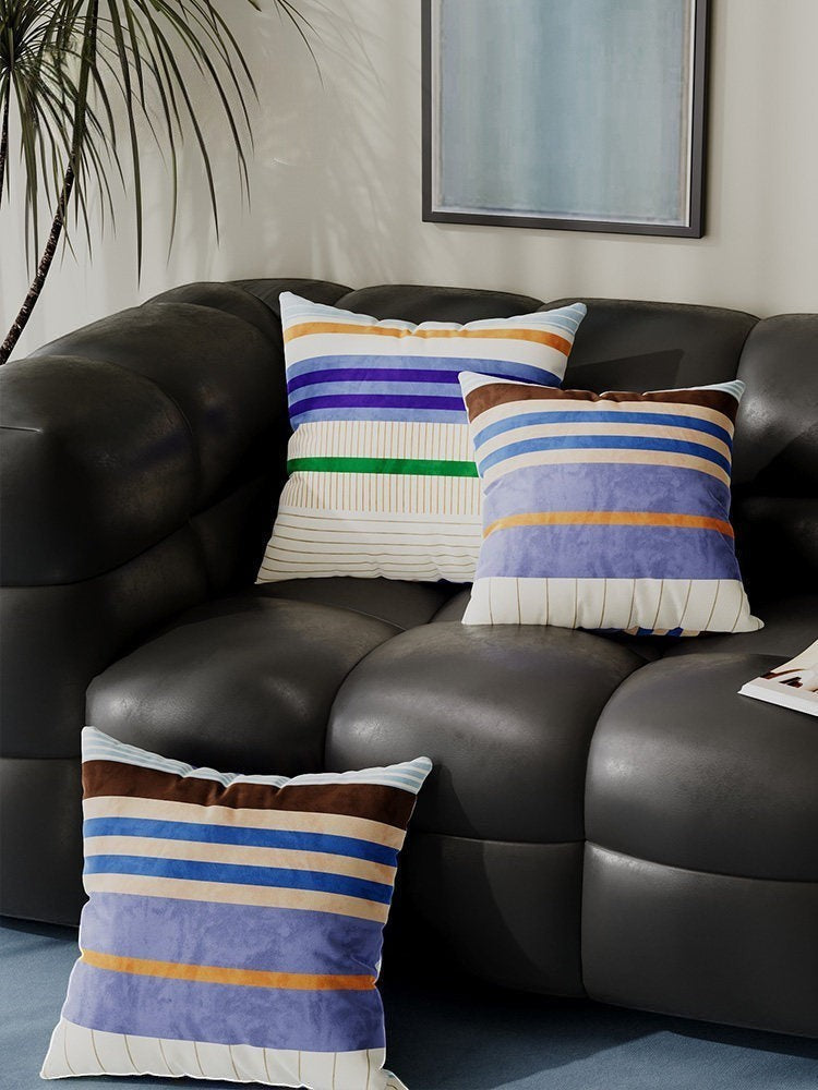 Retro dopamine decor colour block stripe cushion covers in blue, brown, and orange.