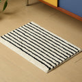 HOMELIVY minimalist striped bath mat rug in black and white, made of soft, absorbent material.