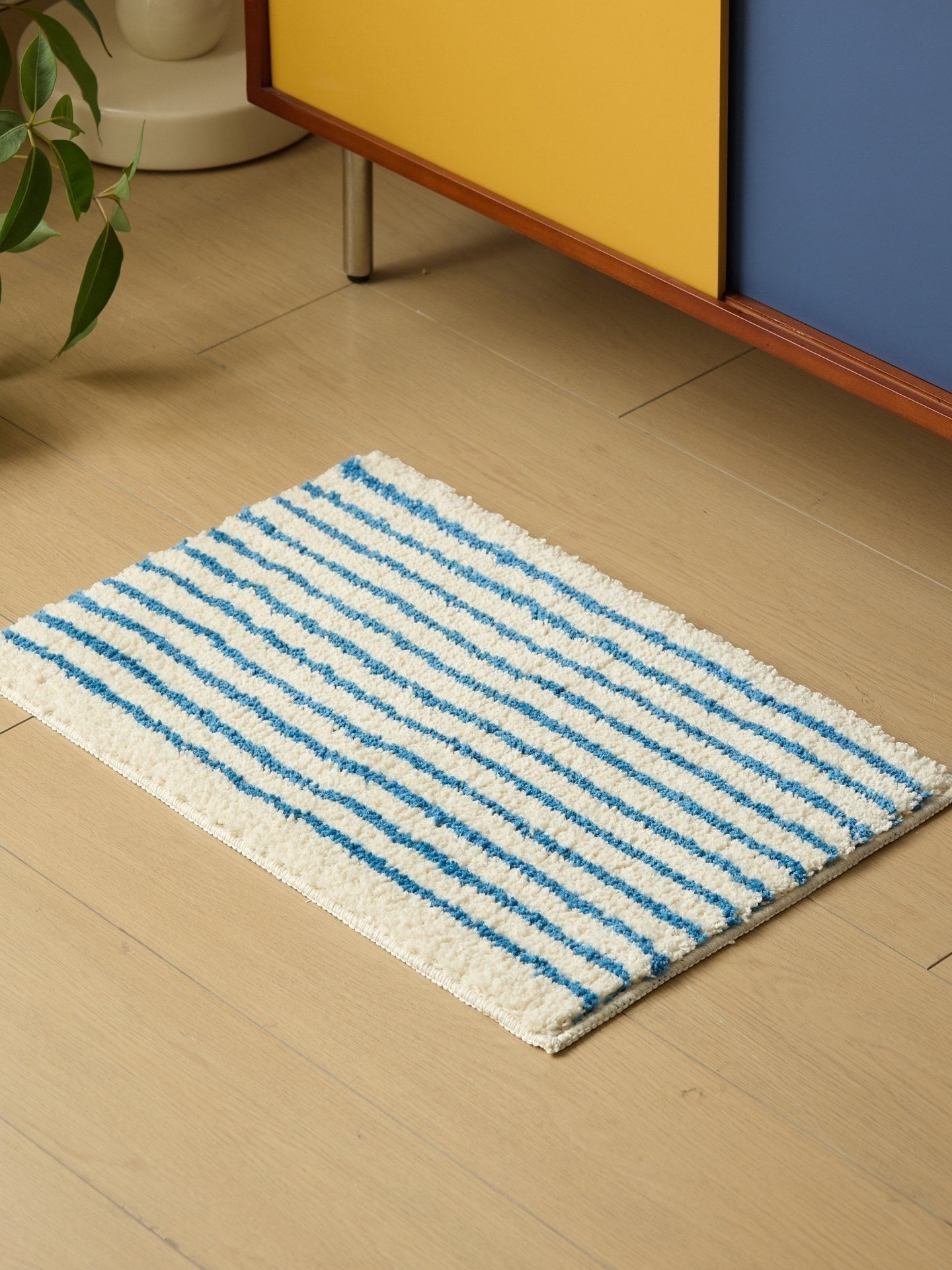 HOMELIVY minimalist striped bath mat rug in white with blue stripes, made of soft, absorbent material.