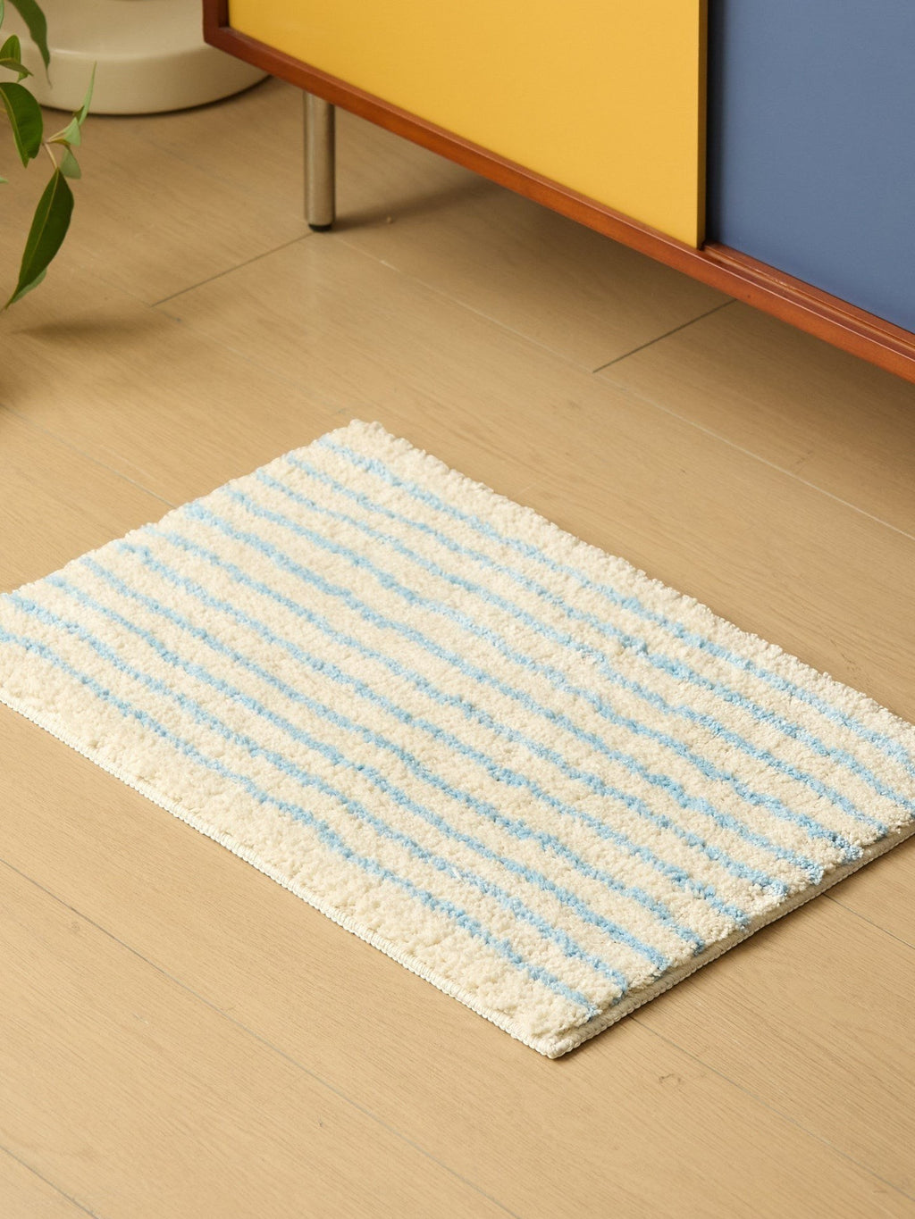 HOMELIVY minimalist striped bath mat rug in cream with blue stripes, soft absorbent cotton material.