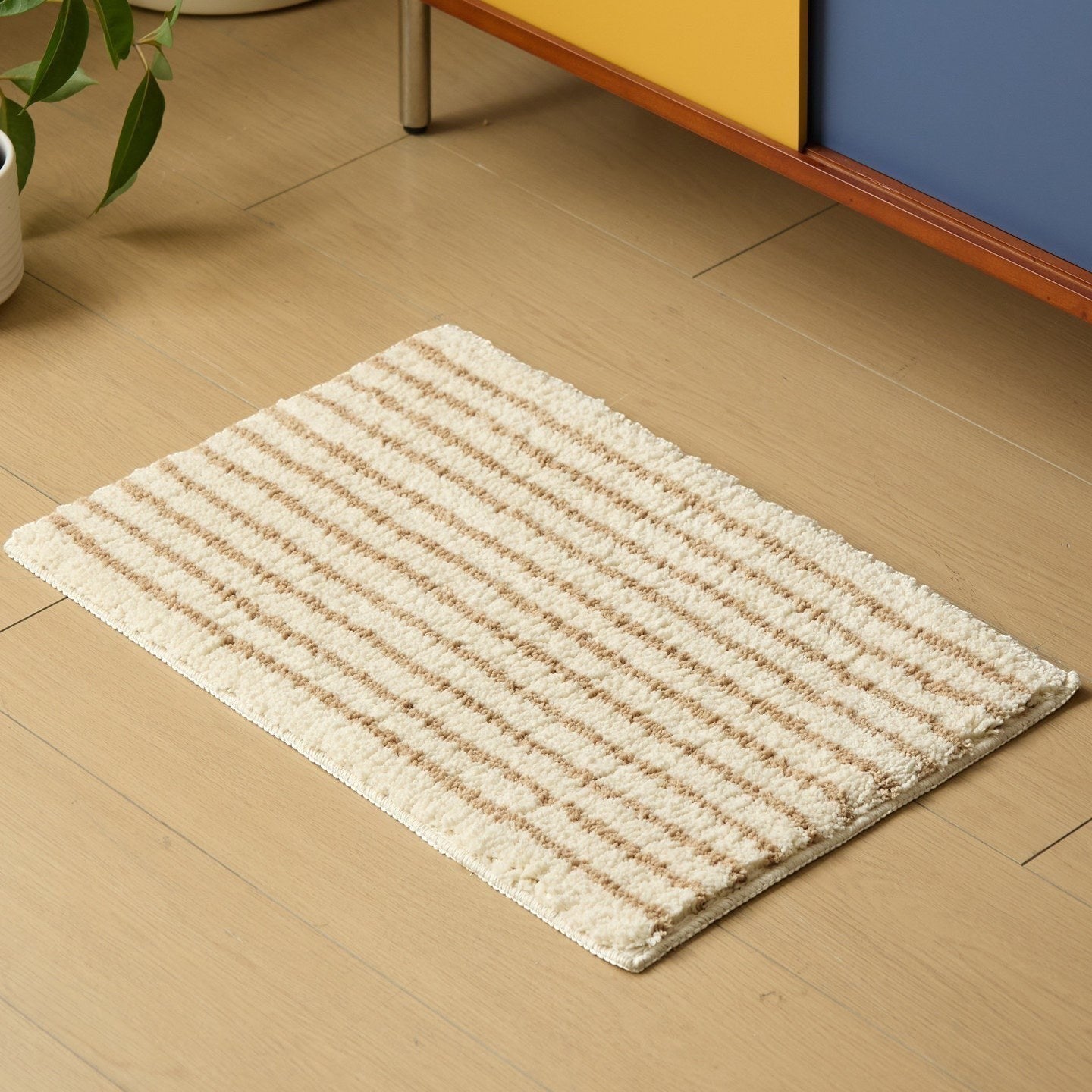 HOMELIVY minimalist striped bath mat rug in cream with brown stripes. Soft, absorbent, and machine washable.
