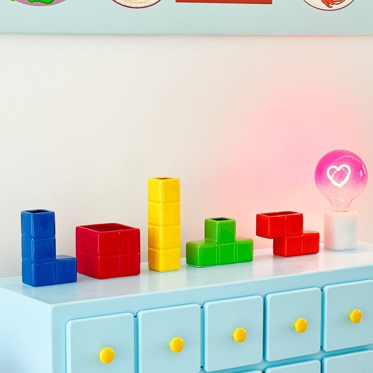 HOMELIVY Tetris decorative ceramic vases in vibrant primary colors displayed on a light blue dresser.