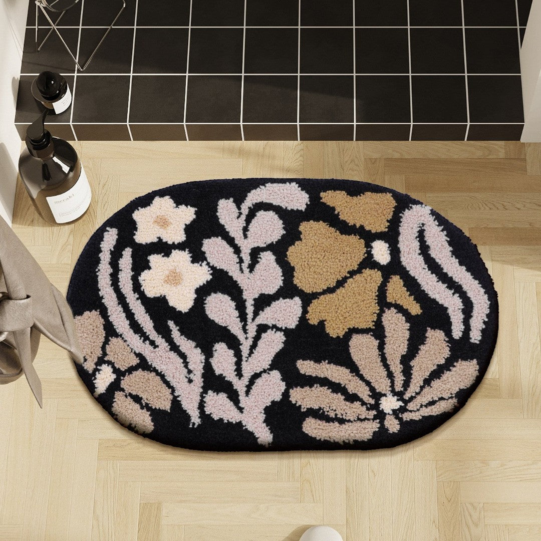 HOMELIVY Vintage Style Floral Bath Mat in black with beige, pink, and tan floral pattern. Oval shape.