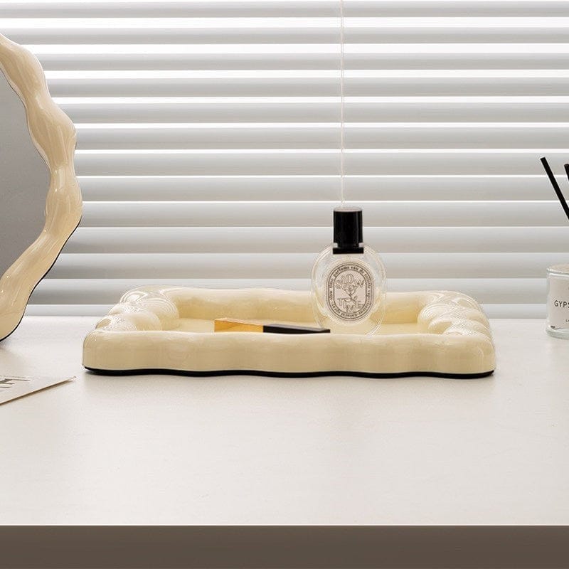 HOMELIVY wavy ceramic tray in cream with rippled edges, perfect for organizing jewelry or decor.