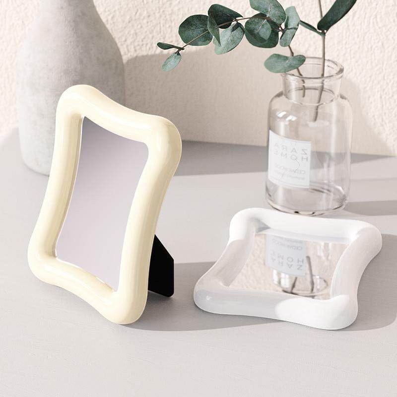 HOMELIVY wavy desk mirror in cream with a glossy finish and black stand. Decorative accent.