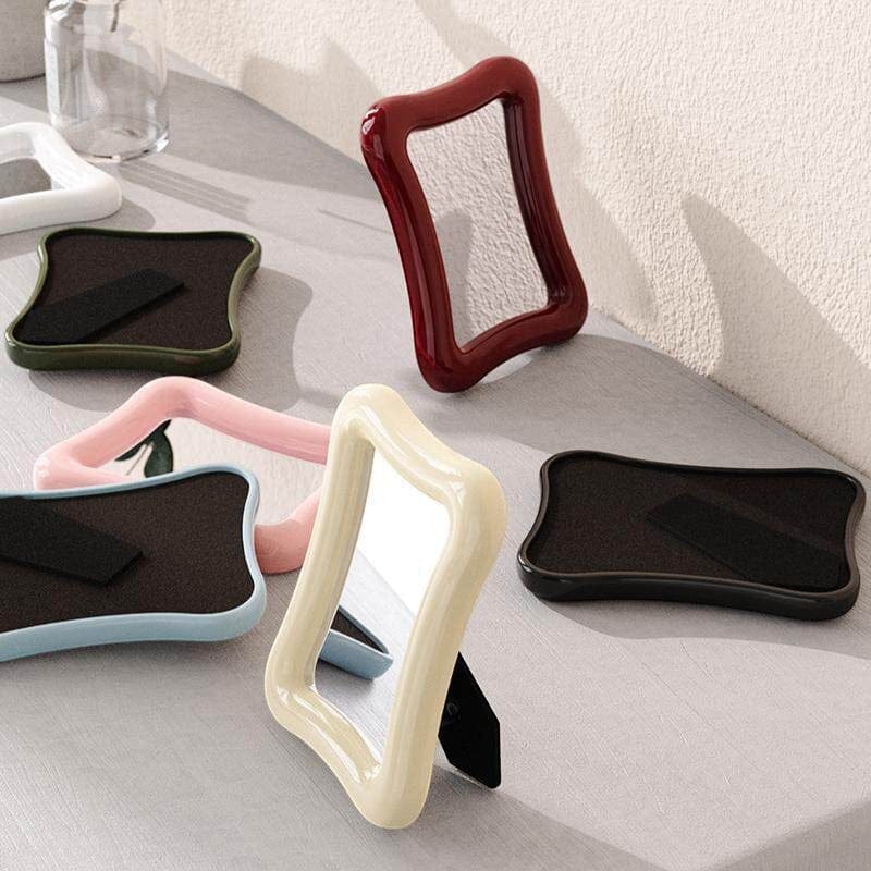 HOMELIVY wavy desk mirror with a glossy finish in cream, red, pink, and blue frames. Perfect for vanities or desks.
