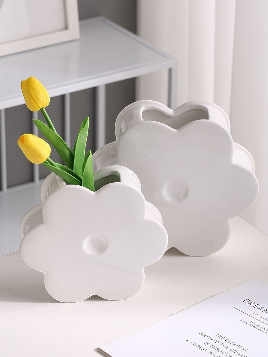 HOMELIVY white ceramic flower-shaped vases holding yellow tulips on a white table