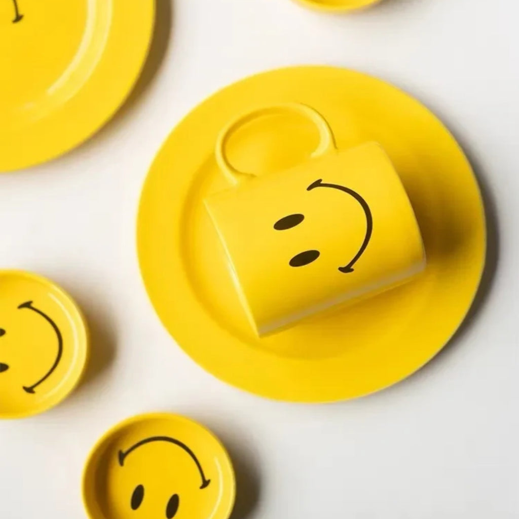 HOMELIVY yellow ceramic mug featuring a smiley face design