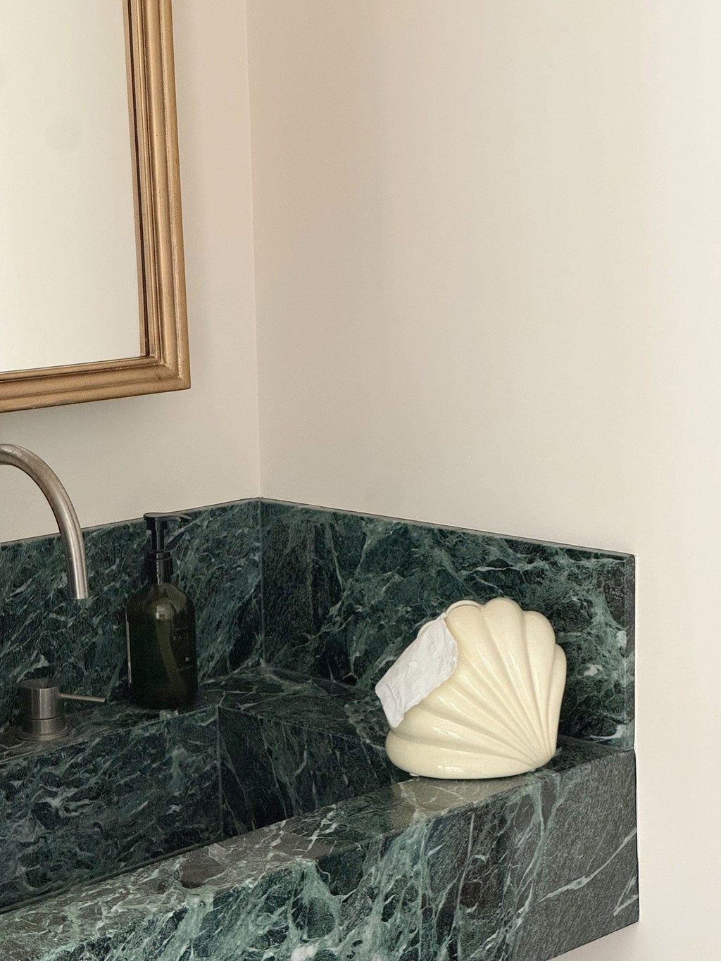 Cream-colored seashell-shaped tissue holder with smooth glossy finish for decorative home use