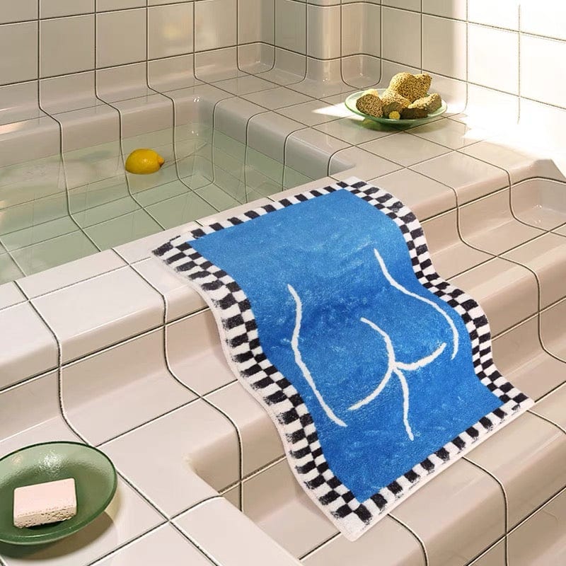 Blue booty bath mat rug showing backside with blue towel featuring white woman outline and black and white checkered border