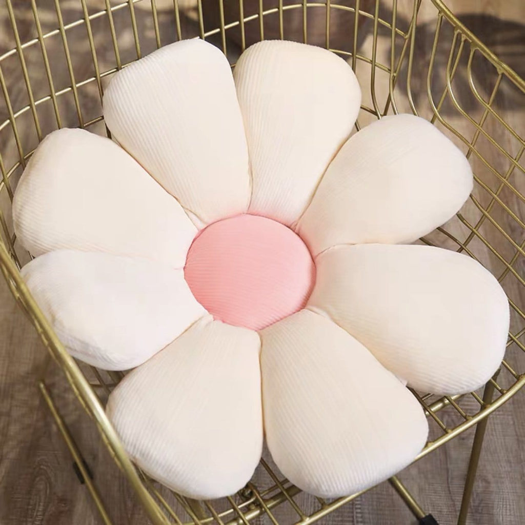 A plush pastel flower cushion with a soft pink center made from ribbed white fabric for decorative use