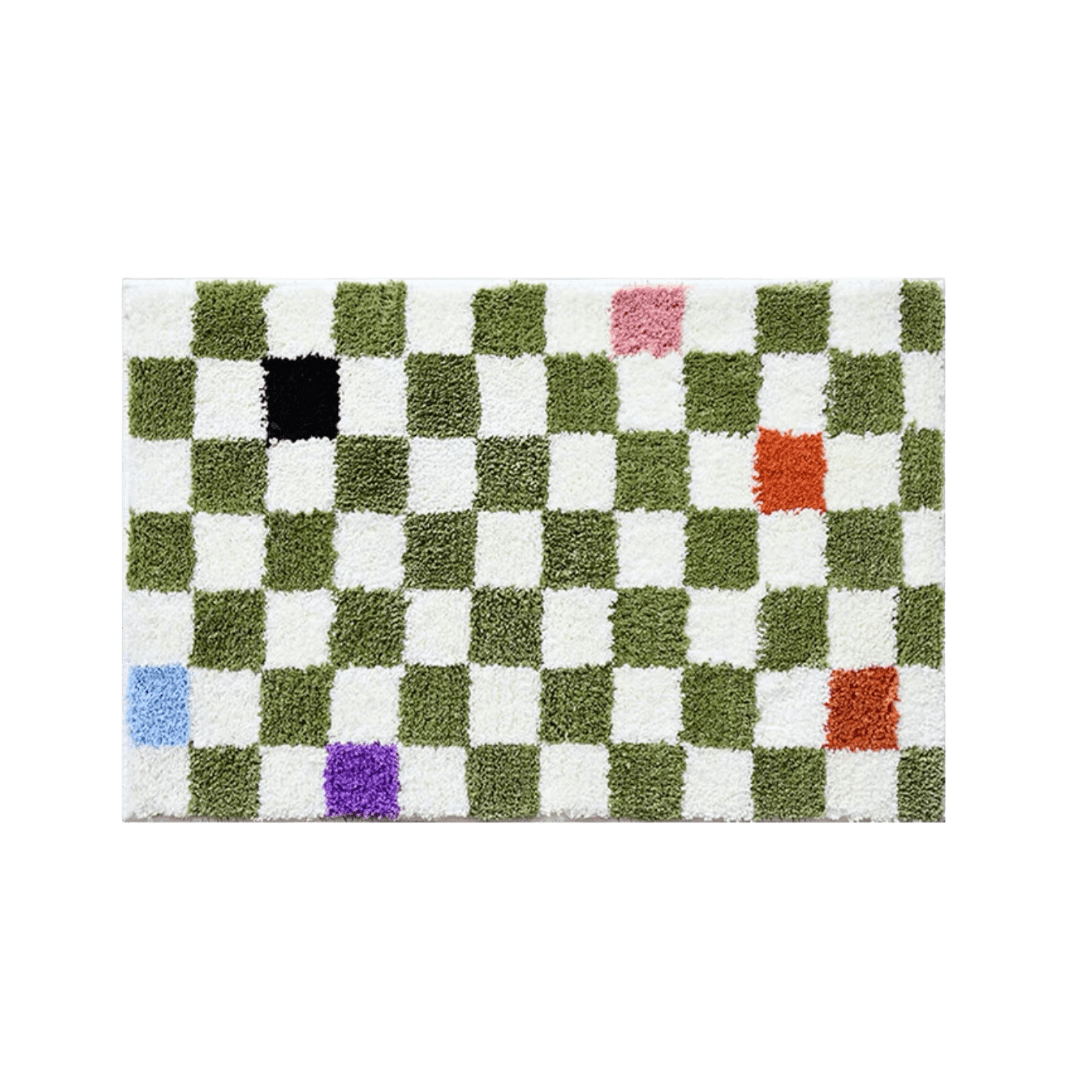 A plush rectangular green color tiles checkered rug with alternating green and white squares and colorful patches