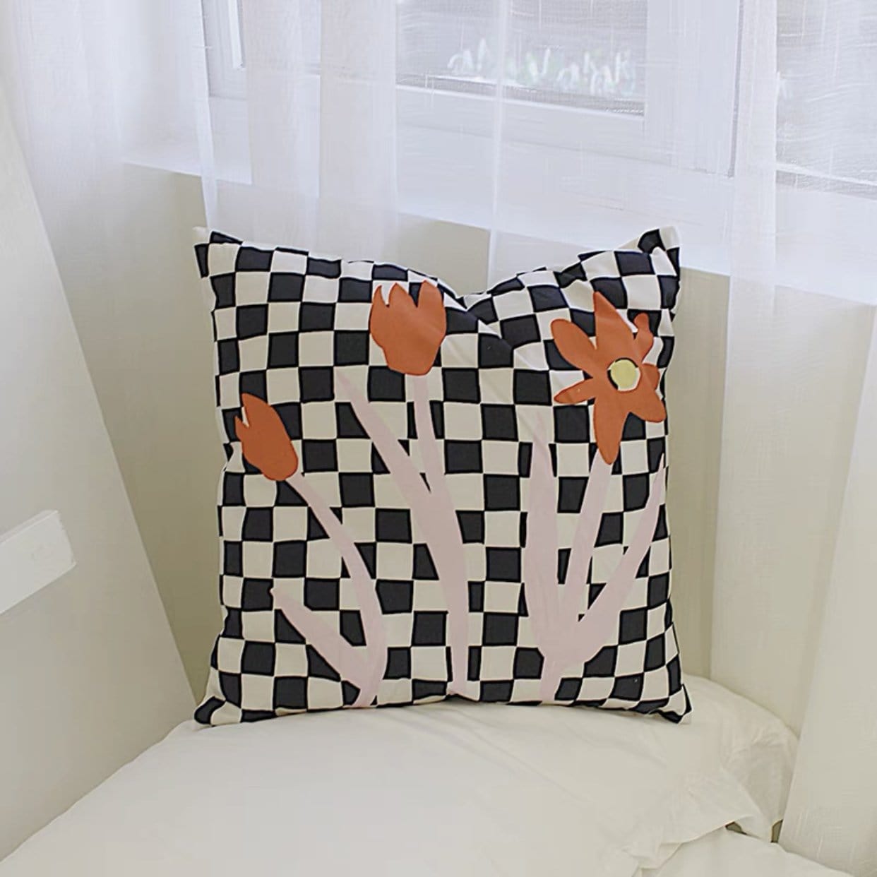 black and white checkered throw pillow with abstract flowers