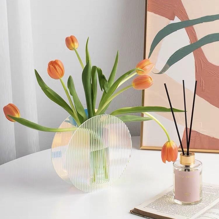 Iridescent arch flower vase made of transparent glass with vertical striped texture for elegant floral display