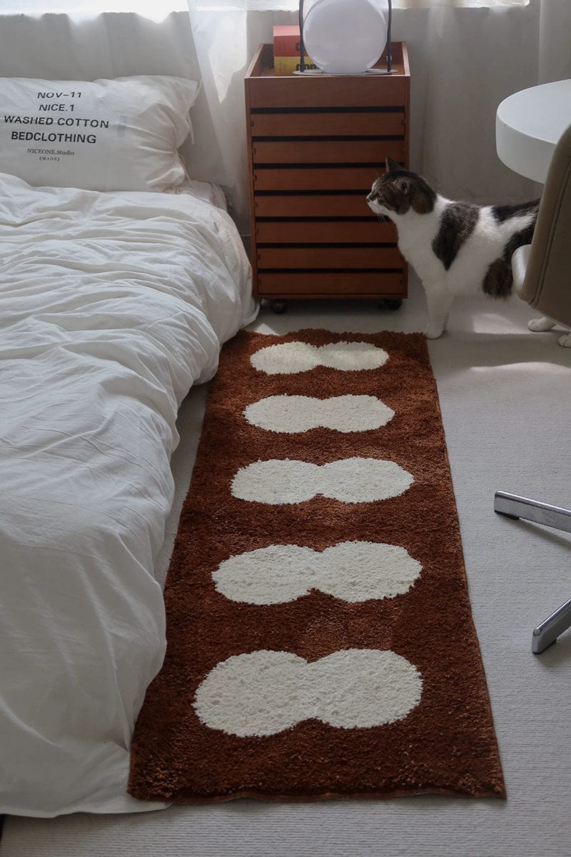 Brown plush minimal runner rug with five white cloud-like oval patterns for hallway or entryway use
