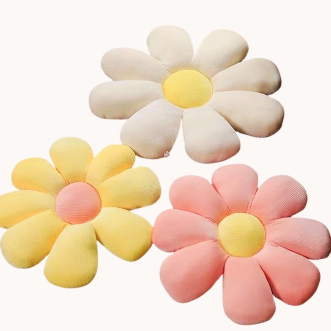 Three plush pastel flower cushions in cream yellow and pink made of textured fabric for cozy home decor