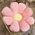Pastel flower cushion is a pink corduroy flower-shaped cushion with a yellow center on a gold wire chair