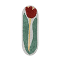 A plush red rose flower rug bath mat with a vibrant red tulip and green leaves on a soft white background