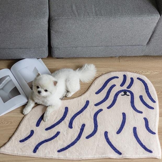 Cream-colored plush shaggy puppy dog rug with navy blue wavy lines forming a dog face design