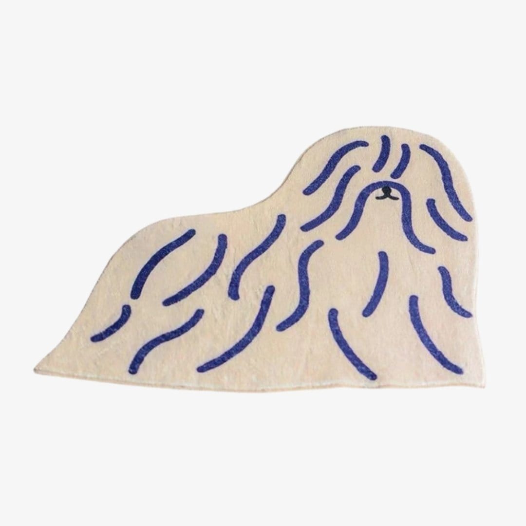 Cream-colored plush shaggy puppy dog rug shaped like a pekingese with navy blue embroidered long fur lines