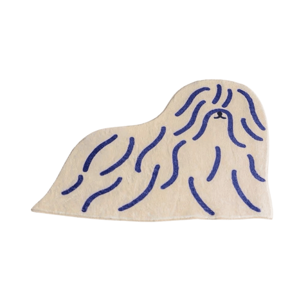 Cream-colored plush shaggy puppy dog rug shaped like a pekingese with navy blue embroidered long fur lines