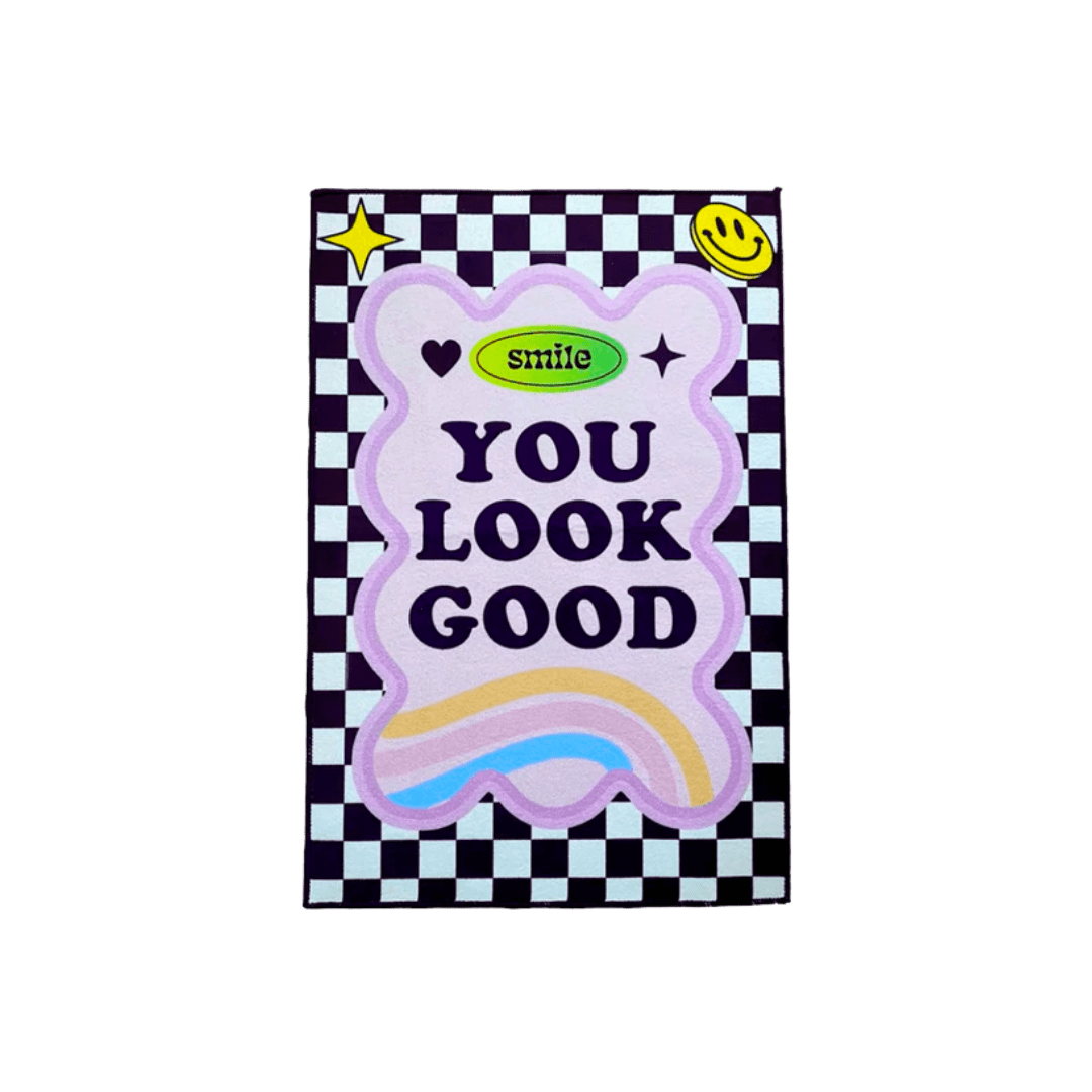 Smile you look good rug with pastel purple cloud shape and rainbow gradient text on black and white checkered background