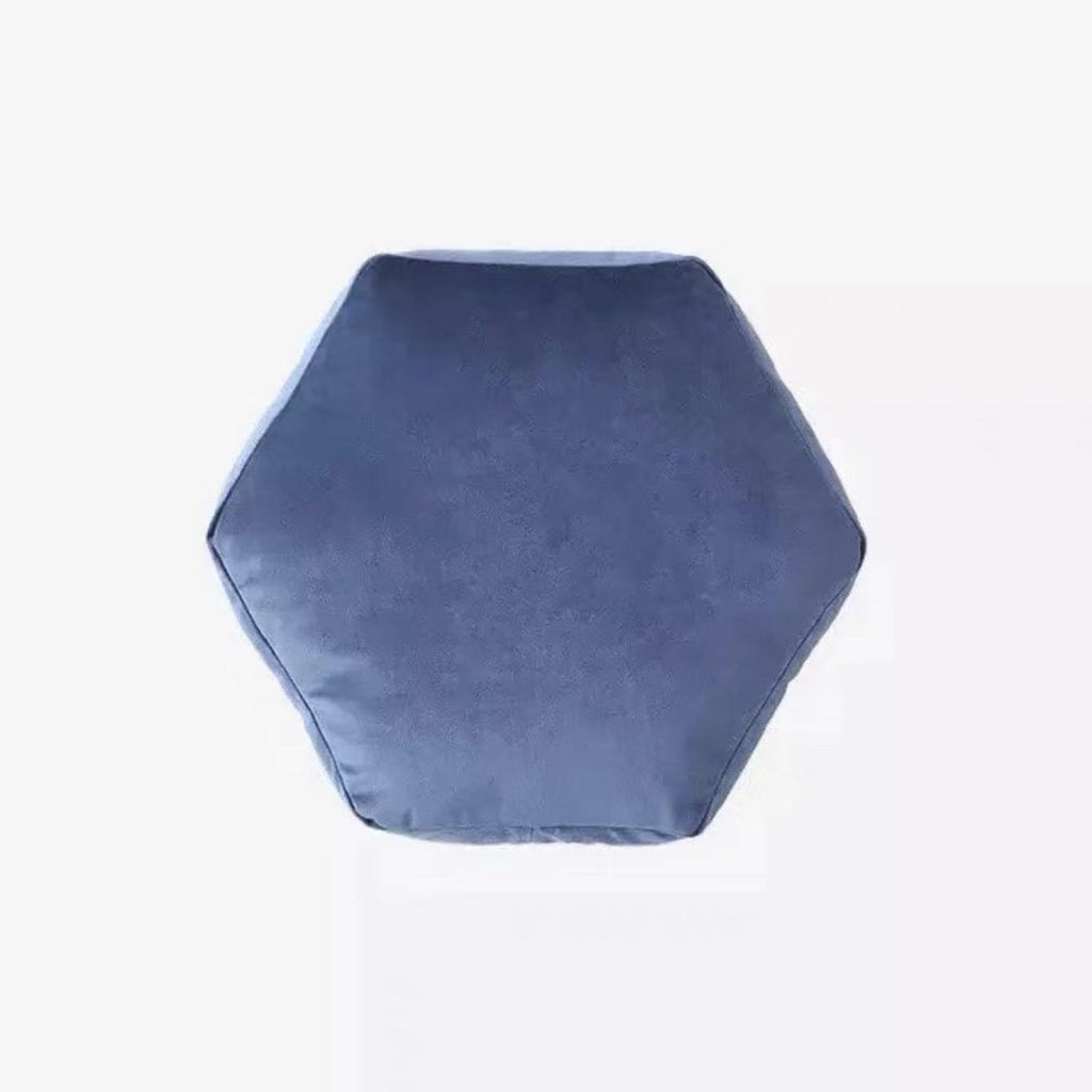 A plush velvet geometry pillow in navy blue with a hexagonal shape and cushioned soft sides and rounded top