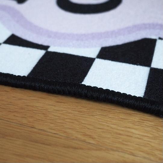Smile you look good rug featuring a black and white checkered plush texture with a soft scalloped edge