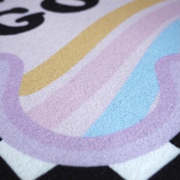 A soft plush smile you look good unicorn rug with a pastel rainbow mane in purple pink yellow and blue
