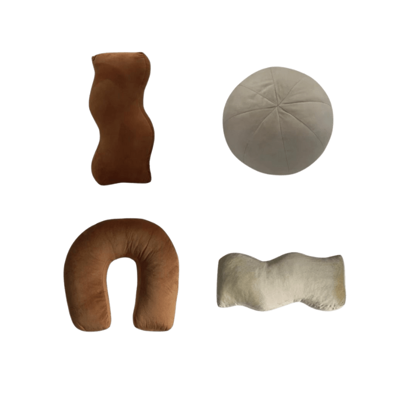Set of four plush travel pillows in earthy tones made of soft velour fabric including wavy, round, and u-shaped neck supports